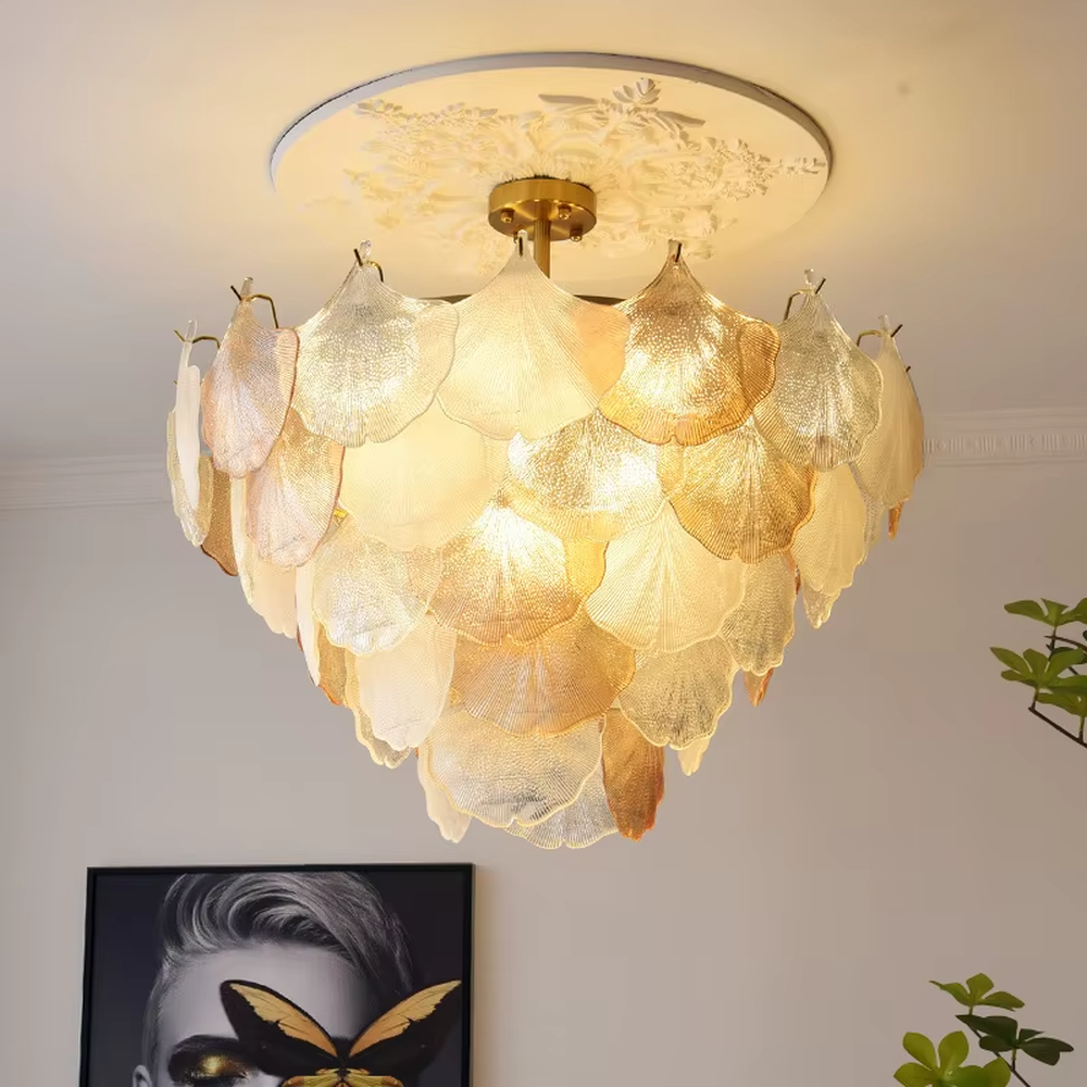 This is an artistic ginkgo leaf-shaped ceiling lamp, featuring gradient (off-white to light gold) textured leaf-shaped lampshades paired with golden metal connectors. The lighting is soft and warm, creating a natural and elegant space atmosphere.