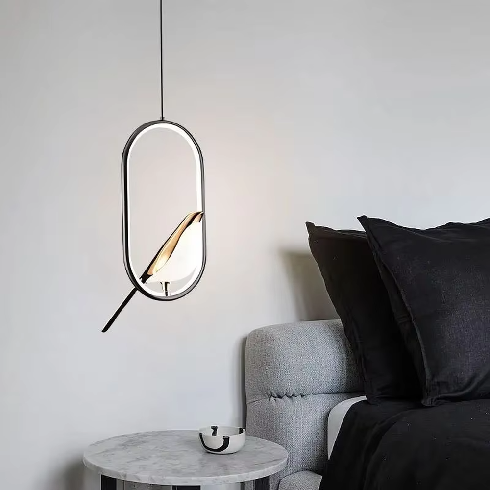 This modern minimalist chandelier features a black metal oval frame, paired with a beveled gold decorative piece and soft LED light source. It has a minimalist and design-conscious shape, serving both lighting and decorative purposes, ideal for modern minimalist spaces such as bedroom bedside tables, living room side tables, and hotel guest rooms.
