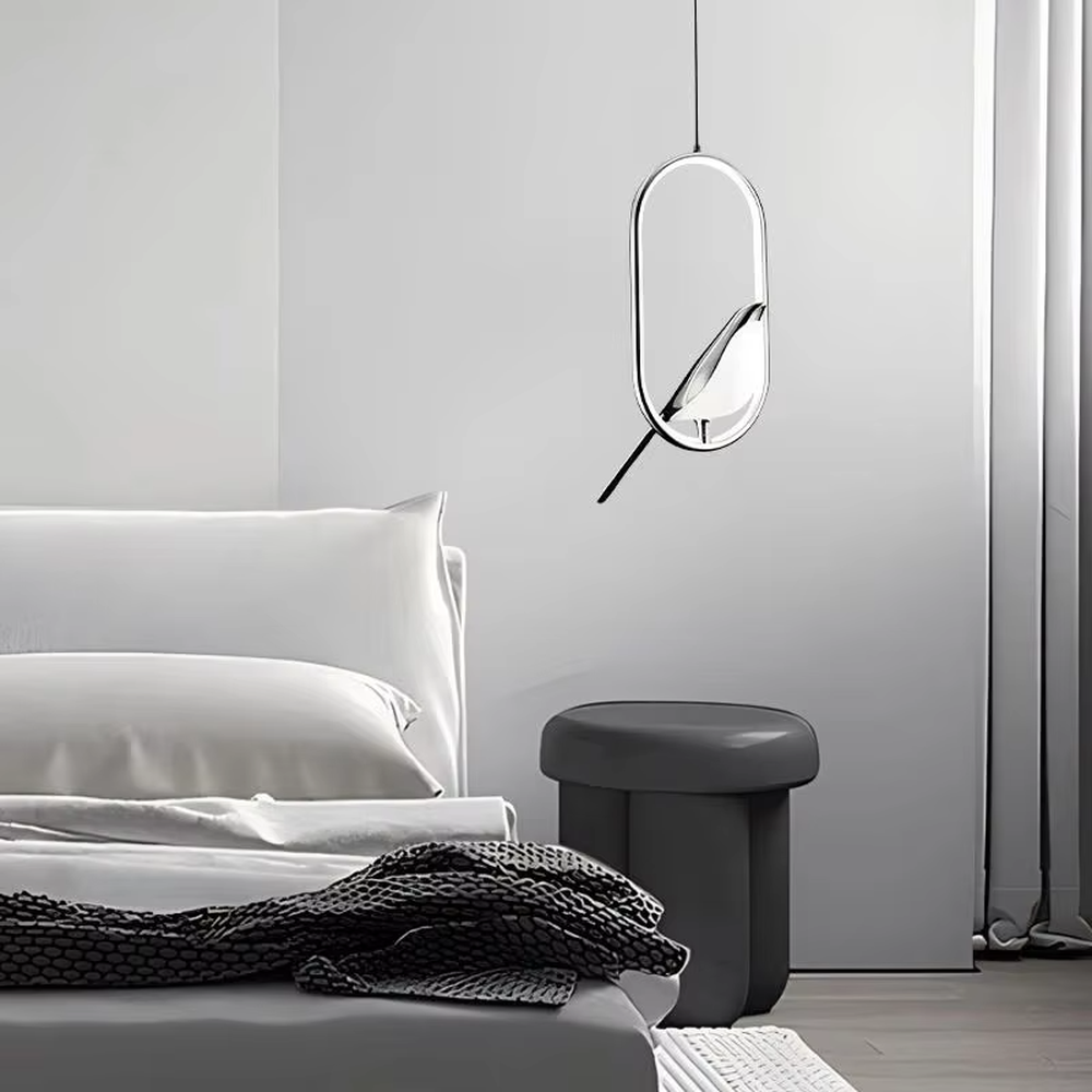 This modern minimalist chandelier features a black metal oval frame, paired with a beveled gold decorative piece and soft LED light source. It has a minimalist and design-conscious shape, serving both lighting and decorative purposes, ideal for modern minimalist spaces such as bedroom bedside tables, living room side tables, and hotel guest rooms.