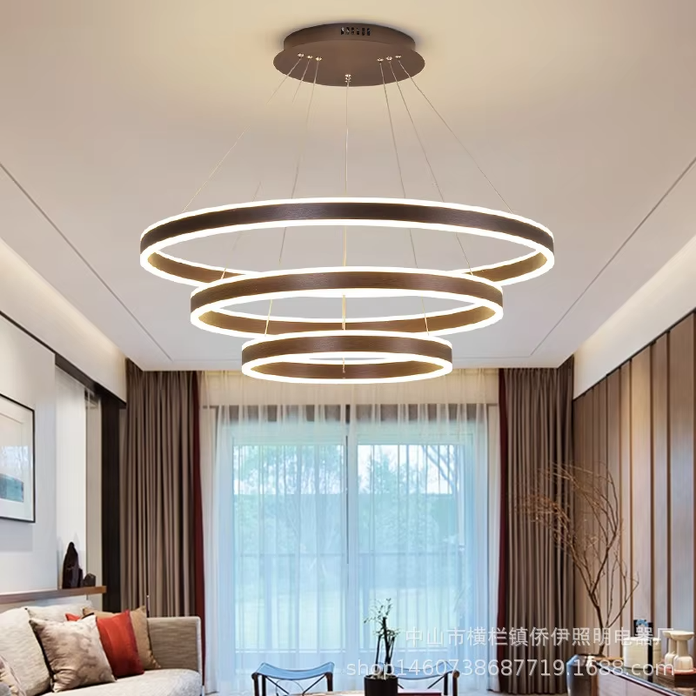 A modern light luxury three-tier ring LED chandelier, featuring a gold metal frame with built-in soft light strips and adjustable suspension rods for different ceiling heights, combining lighting and decorative functions, ideal for creating a minimalist and sophisticated space atmosphere.