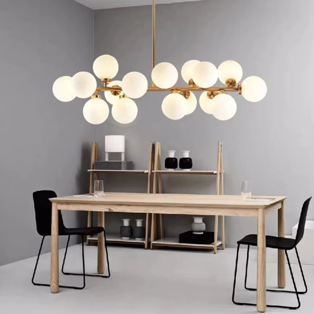 A modern light luxury style linear molecular ball chandelier, featuring a gold metal frame paired with multiple milky white glass glowing spheres of varying sizes, shaped like a star cluster or molecular structure suspended in space. It emits a soft and uniform glow when lit, combining decorative appeal with practical illumination, ideal for creating a minimalist and sophisticated space atmosphere.