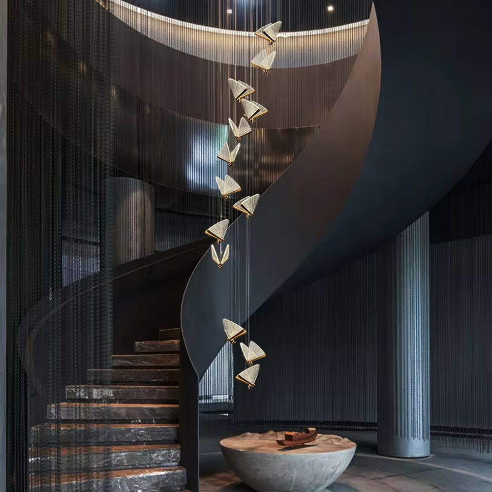 Light luxury butterfly-wing shaped chandelier, featuring butterfly wing textures made of colored mosaic glass, paired with a gold metal base and hanging structure. It emits soft, transparent, and colorful light, combining artistic decorativeness and lighting function, suitable for atmosphere creation and supplementary lighting in spaces such as entrances, stairwells, and bedroom nightstands.