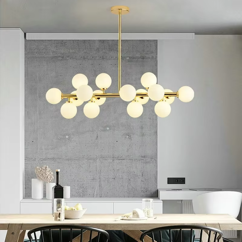 A modern light luxury style linear molecular ball chandelier, featuring a gold metal frame paired with multiple milky white glass glowing spheres of varying sizes, shaped like a star cluster or molecular structure suspended in space. It emits a soft and uniform glow when lit, combining decorative appeal with practical illumination, ideal for creating a minimalist and sophisticated space atmosphere.
