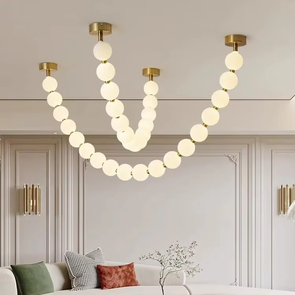 Modern Light Luxury Curved Beaded Chandelier, Milk White Spherical Lampshades Connected in a Wave Shape, Gold Metal Base, Serves Both Lighting and Decorative Purposes, Ideal for Living Rooms, Dining Rooms, Open Kitchens, etc.