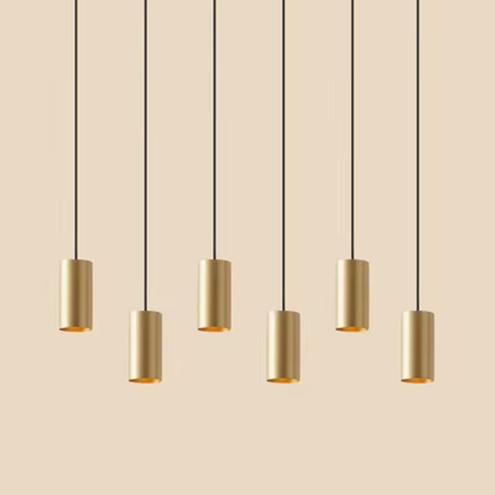 This is a modern light luxury gold cylindrical triple-head pendant light, featuring a linear bronze metal base paired with cylindrical lamp bodies, with a staggered hanging design that is simple and neat. It emits soft and uniform light, serving both lighting and decorative purposes, suitable for dining rooms, bars, minimalist living rooms and other scenarios.
