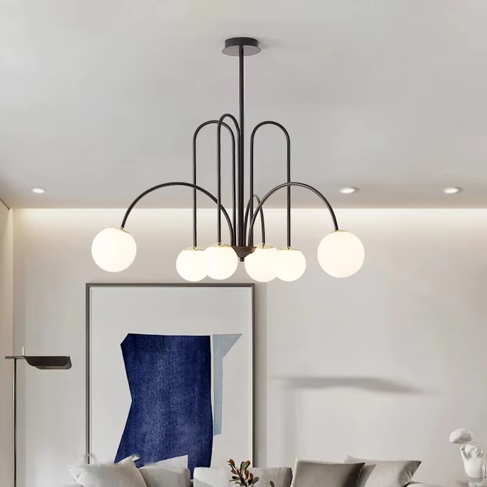 A multi-head chandelier combining modern light luxury and French retro styles, featuring a gold metal curved branch frame paired with milky white glass glowing spheres of varying sizes. It emits soft and uniform warm light when lit, combining decorative appeal with practical illumination, ideal for creating an elegant and dynamic space atmosphere.