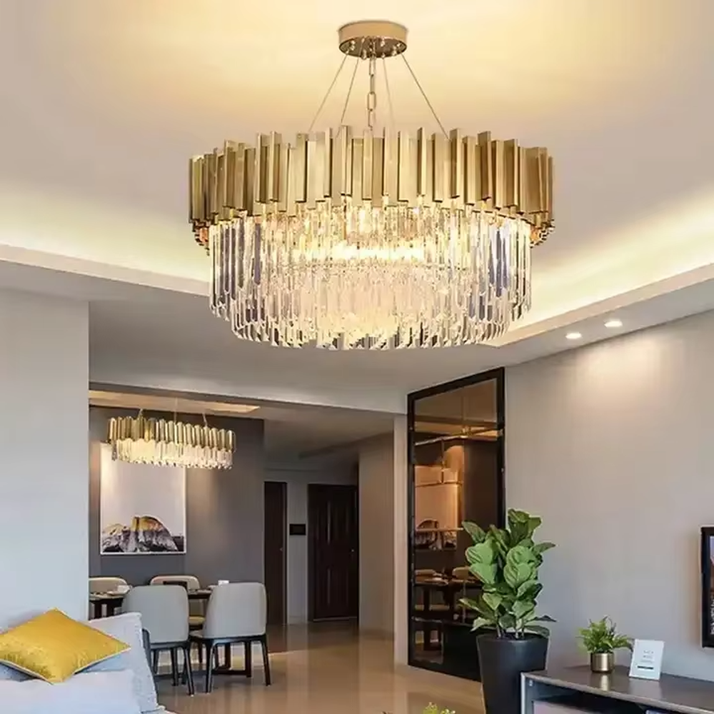 This is a light luxury and luxurious style multi-layer crystal chandelier, with a gold metal top paired with a transparent crystal column pendant structure, which has both lighting and decorative functions, suitable for high-end spaces such as villa high-ceiling living rooms, duplex stairwells, and hotel lobbies.