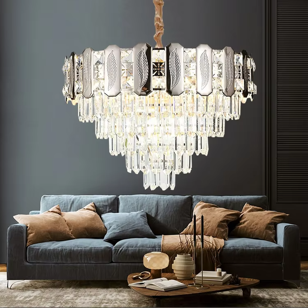 This is a light luxury cascading crystal chandelier, with a top metal frame inlaid with leaf-textured decorative panels and cut crystals, and densely cascading crystal strips hanging below, featuring brilliant and soft light, both decorative and lighting functions, ideal for high-end indoor spaces such as living rooms and dining rooms.