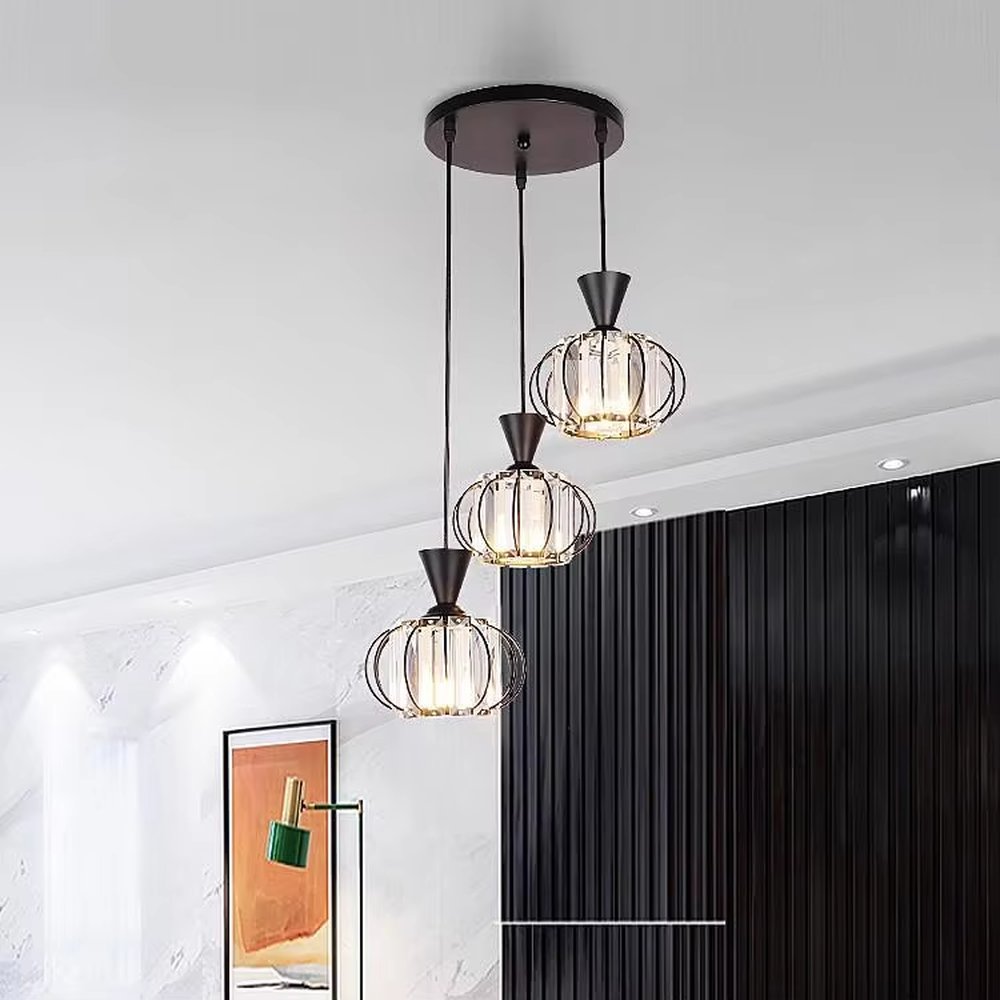 A modern industrial-style 3-head chandelier, featuring a staggered spherical cage frame made of black iron, paired with striped glass lampshades. It emits a soft and transparent glow when lit, combining decorative appeal with practical illumination, ideal for creating a bold and minimalist space atmosphere.