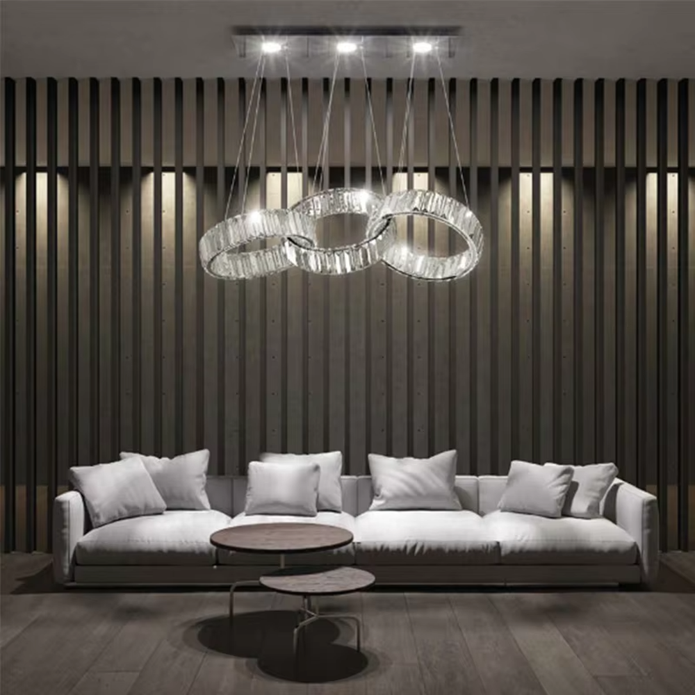 Modern light luxury chain-style ring crystal chandelier, composed of multiple transparent crystal rings connected into a flexible chain shape, paired with metal suspension rods and a long top base, combining decorative and lighting functions, suitable for dining rooms, living rooms, villas and other light luxury style spaces.