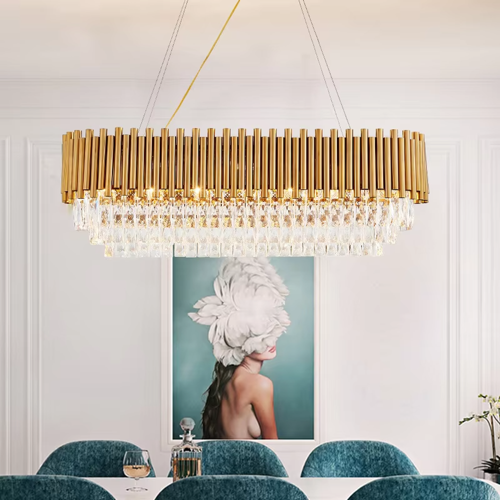 This light luxury double-layer oval chandelier consists of upper gold metal vertical strips and lower faceted crystal pendants. Light refracts through the crystals to emit a brilliant glow, serving both lighting and decorative purposes, suitable for high-end spaces such as villa living rooms and light luxury dining rooms.