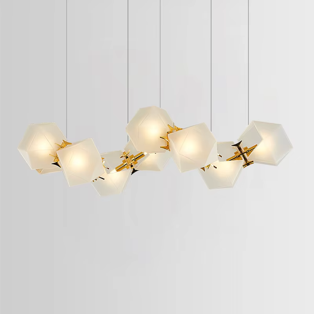 A modern light luxury style wave-shaped linear chandelier, suspended by gold wires, paired with frosted geometric polyhedral lampshades. It emits a soft and warm glow when lit, combining decorative appeal with practical illumination, ideal for creating an exquisite and high-end space atmosphere.