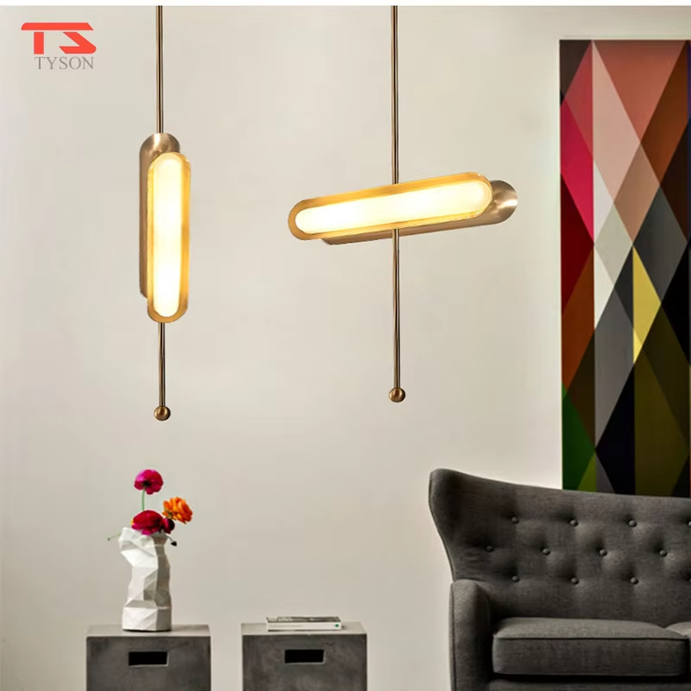 This is a modern light luxury cross-shaped artistic pendant light, featuring a bronze metal frame paired with an oval soft light-emitting lamp body, with simple and balanced lines, serving both lighting and decorative purposes, suitable for entrances, bedroom headboards, light luxury bars, minimalist living rooms and other scenarios.
