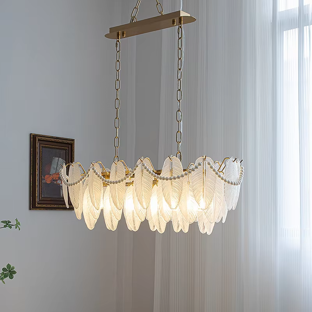 A French light luxury style feather glass chandelier, featuring a gold metal frame paired with double-layer feather-textured glass panels and pearl chain decorations. It emits a soft and warm glow when lit, combining decorative appeal with practical illumination, ideal for creating a romantic and elegant space atmosphere.