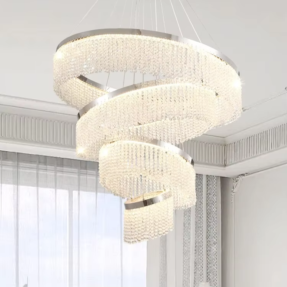 Modern light luxury three-layer spiral ring crystal chandelier, composed of dense crystal particles and silver metal frames in a staggered spiral structure, emitting brilliant and soft light, combining artistic decorativeness and lighting function, suitable for core lighting and atmosphere creation in living rooms, dining rooms, villa high-ceiling spaces, etc.