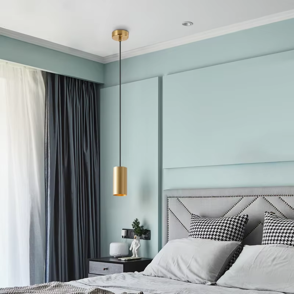 This is a modern light luxury gold cylindrical triple-head pendant light, featuring a linear bronze metal base paired with cylindrical lamp bodies, with a staggered hanging design that is simple and neat. It emits soft and uniform light, serving both lighting and decorative purposes, suitable for dining rooms, bars, minimalist living rooms and other scenarios.