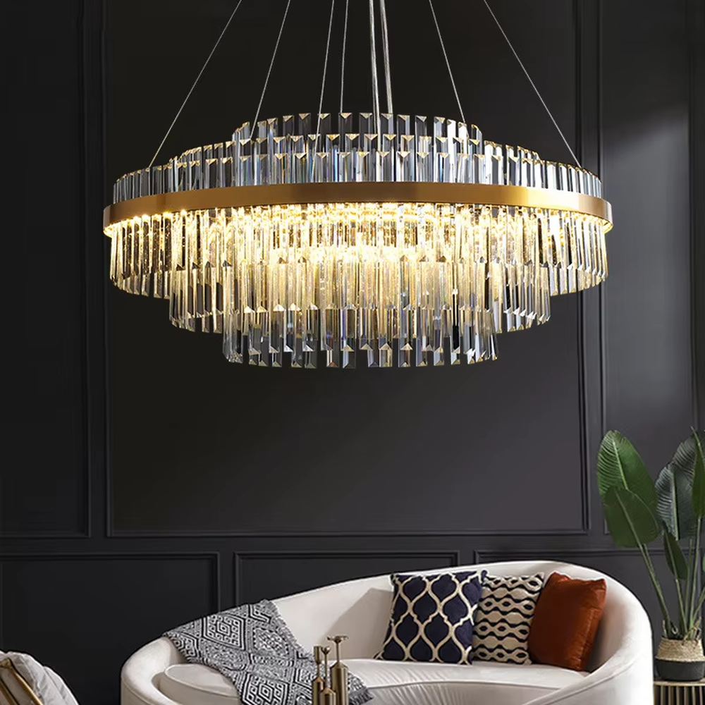 A modern light luxury style circular double-layer crystal chandelier, featuring a gold metal frame paired with multiple layers of long cut crystal strips. It emits a brilliant and soft glow when lit, combining decorative appeal with practical illumination, ideal for creating a luxurious and high-end space atmosphere.
