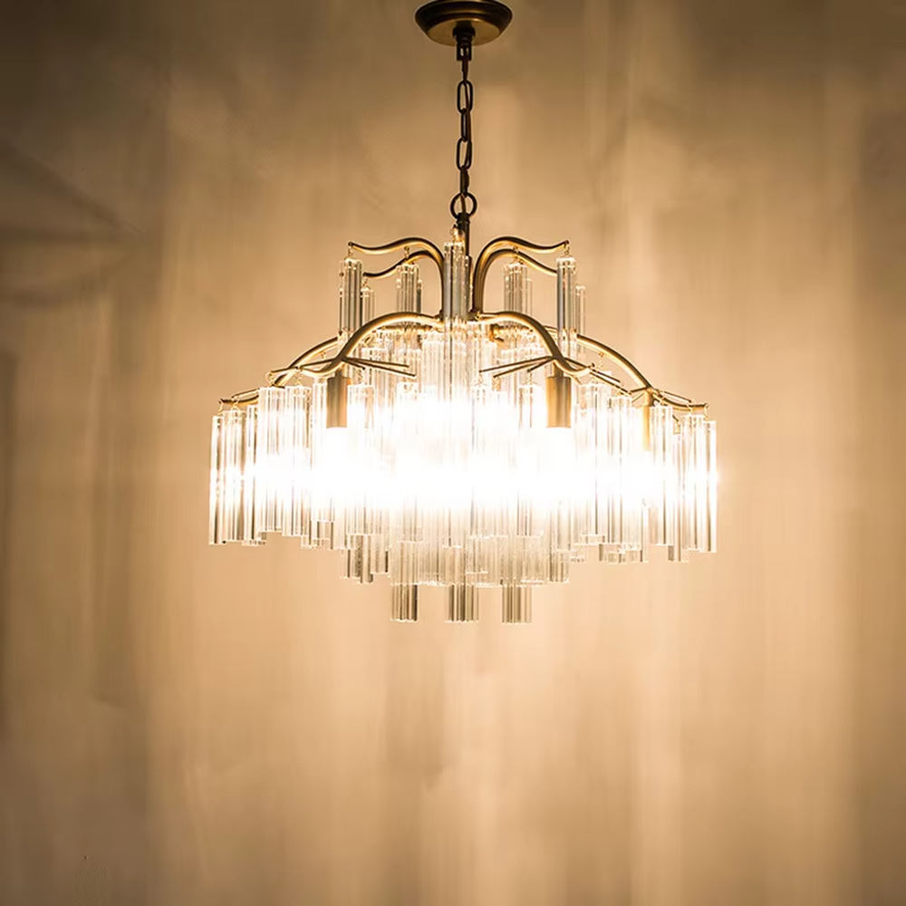 This light luxury golden branch cloud waterfall chandelier features a cloud shape made of golden branch-like metal frames and transparent crystal strips, with light refracting a soft halo through the crystals, serving both lighting and decorative purposes, suitable for modern light luxury spaces such as living rooms and dining rooms.