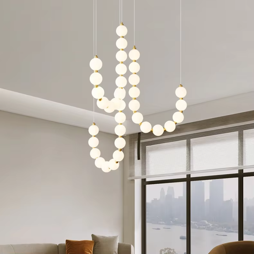 Modern Light Luxury Curved Beaded Chandelier, Milk white spherical lamps connected in a wave shape with gold metal details, serves both lighting and decorative purposes, ideal for duplex stairwells, high-ceiling living rooms, villas and other high-ceiling spaces.
