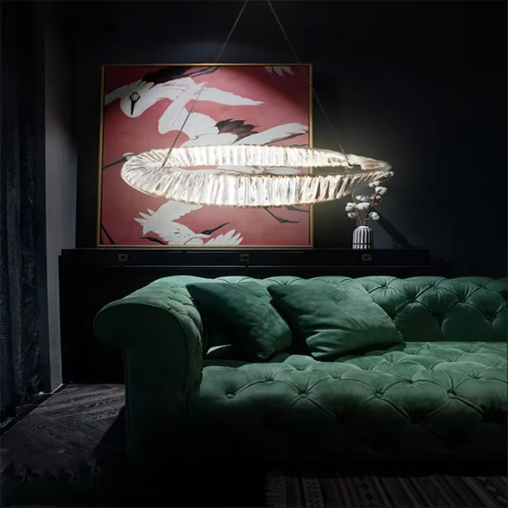 A light luxury and glamorous oval crystal chandelier, constructed with multiple transparent crystal panels joined into a ring-shaped body. It emits a soft and brilliant glow when lit, combining artistic decoration with lighting functionality, ideal for creating a high-end and sophisticated space atmosphere.