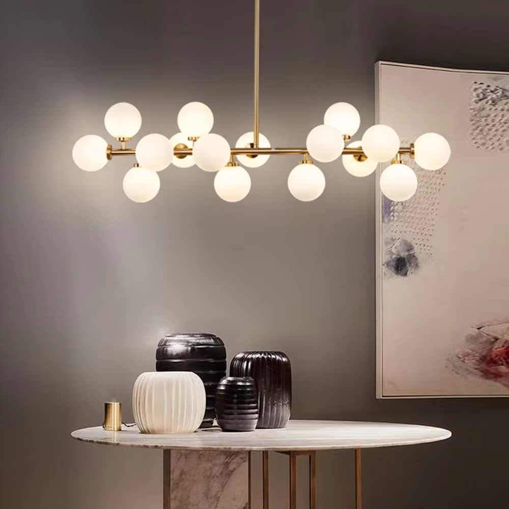A modern light luxury style linear molecular ball chandelier, featuring a gold metal frame paired with multiple milky white glass glowing spheres of varying sizes, shaped like a star cluster or molecular structure suspended in space. It emits a soft and uniform glow when lit, combining decorative appeal with practical illumination, ideal for creating a minimalist and sophisticated space atmosphere.