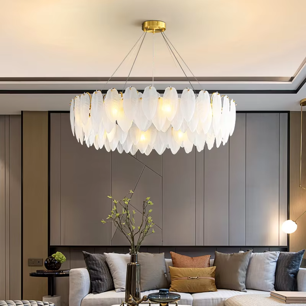 A modern light luxury style ring chandelier, featuring a gold metal frame paired with double-layer feather-shaped gradient glass panels. It emits a soft and warm glow when lit, combining decorative appeal with practical illumination, ideal for creating a romantic and elegant space atmosphere.
