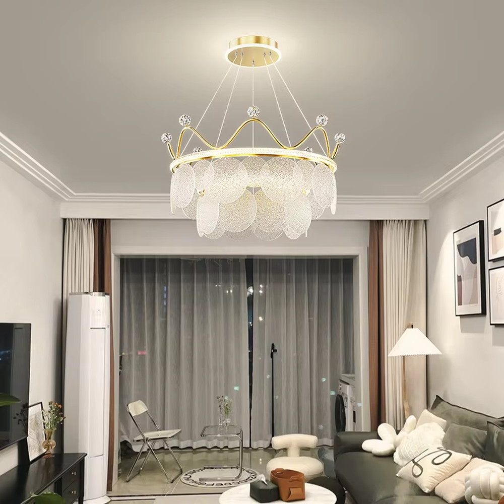 A light luxury princess-style crown-shaped chandelier, featuring a gold metal crown frame paired with crystal decorations and glowing glass lampshades. It emits a brilliant yet soft glow when lit, combining decorative appeal with practical illumination, ideal for creating a romantic and dreamy space atmosphere.