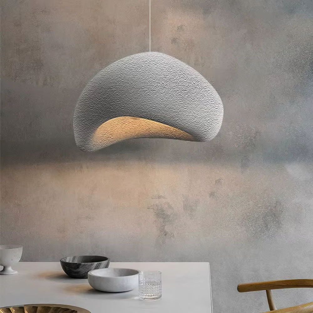 This is a wabi-sabi style hemispherical chandelier, crafted from a textured gray cement-like material, emitting soft warm light from its edge, serving both lighting and decorative purposes, suitable for wabi-sabi style dining rooms, Japanese tea rooms, minimalist living rooms, homestay guest rooms and other scenarios pursuing a relaxed feeling.