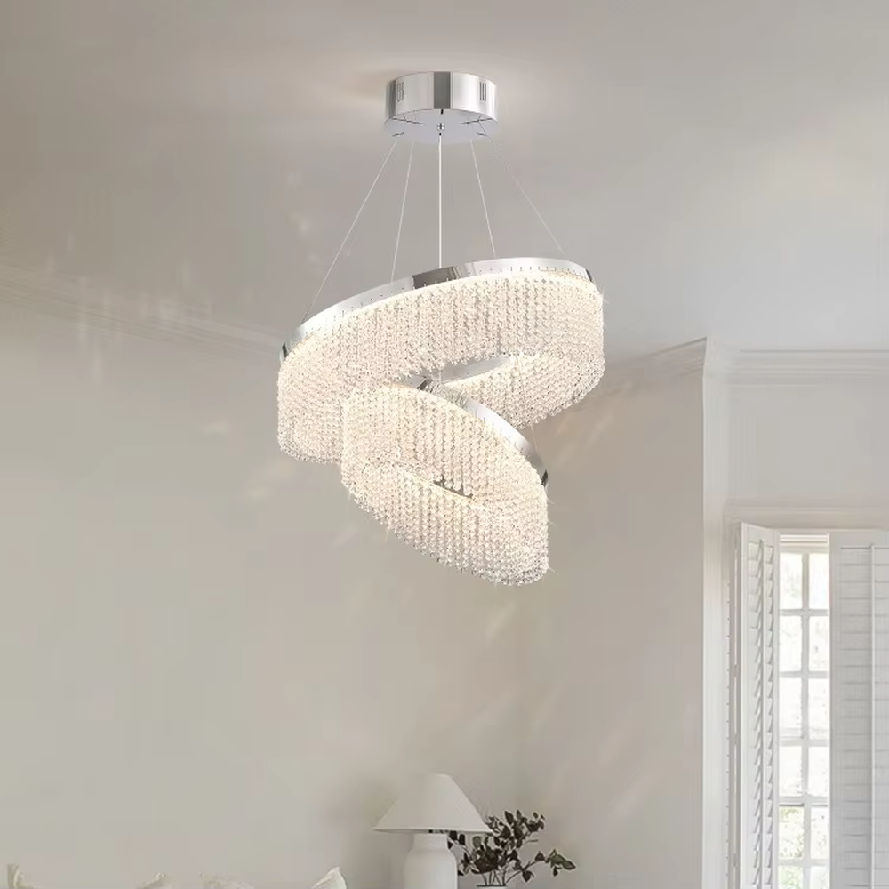 Modern light luxury double-ring spiral crystal chandelier, composed of dense crystal particles and a silver metal frame, presenting a flowing spiral shape. It emits brilliant and soft light, combining artistic decorativeness and lighting function, suitable for core lighting and atmosphere creation in living rooms, dining rooms, villa high-ceiling spaces, etc.