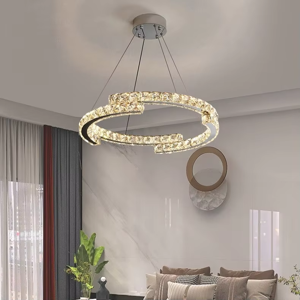 This light luxury interlaced ring crystal chandelier features a multi-layer flowing ring shape made of metal frames and crystal strips, with light refracting a brilliant halo through the crystals, serving both lighting and decorative purposes, suitable for modern light luxury spaces such as living rooms and dining rooms.
