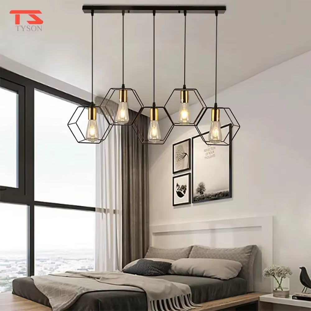 An industrial style 5-head linear chandelier, featuring geometric cage lampshades made of dark brown metal paired with vintage filament bulbs. Its linear arrangement combines decorative appeal with practical illumination, ideal for creating a bold and rugged space atmosphere.