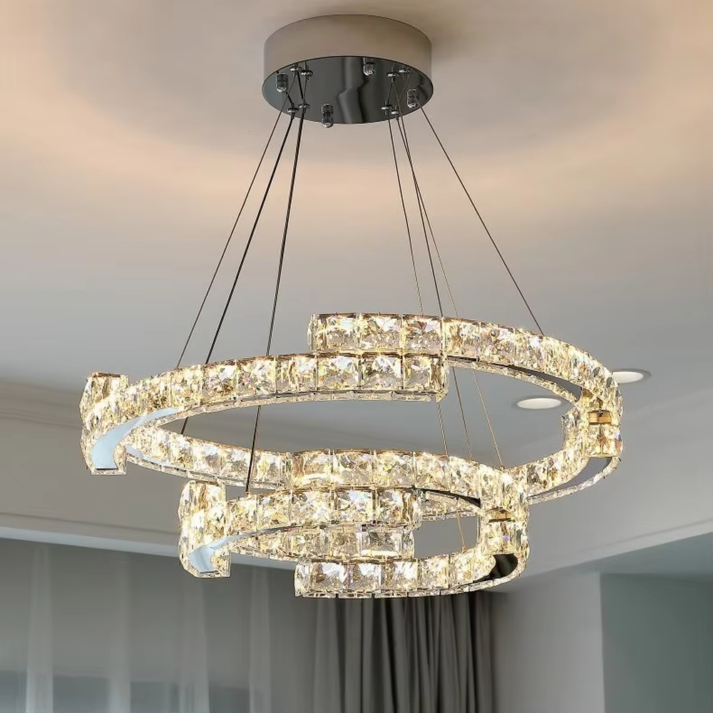 This light luxury interlaced ring crystal chandelier features a multi-layer flowing ring shape made of metal frames and crystal strips, with light refracting a brilliant halo through the crystals, serving both lighting and decorative purposes, suitable for modern light luxury spaces such as living rooms and dining rooms.
