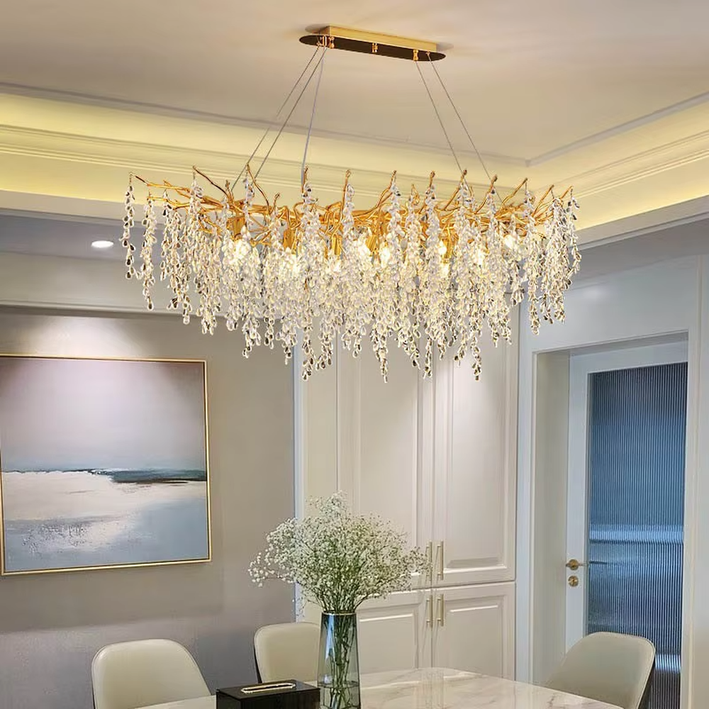 This is a light luxury art-style branch-shaped crystal chandelier, with a gold metal branch frame paired with densely hanging crystal pendants, presenting a dynamic flower cluster blooming effect, with both decorative and lighting functions, ideal for high-end indoor spaces such as living rooms and dining rooms.