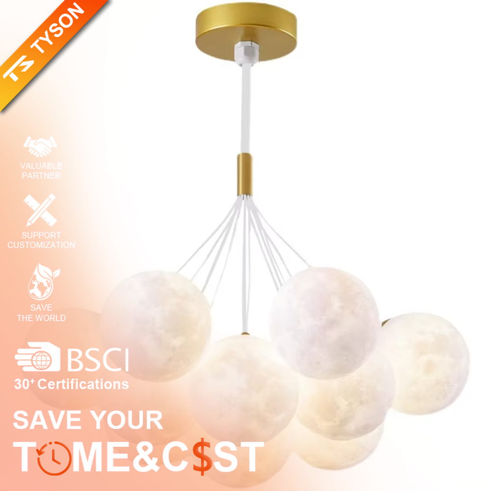 A modern light luxury style moon cluster chandelier, featuring a gold metal frame paired with multiple moon-textured glowing spheres and one colorful nebula sphere. It emits a soft and dreamy glow when lit, combining decorative appeal with practical illumination, ideal for creating a romantic and playful space atmosphere.