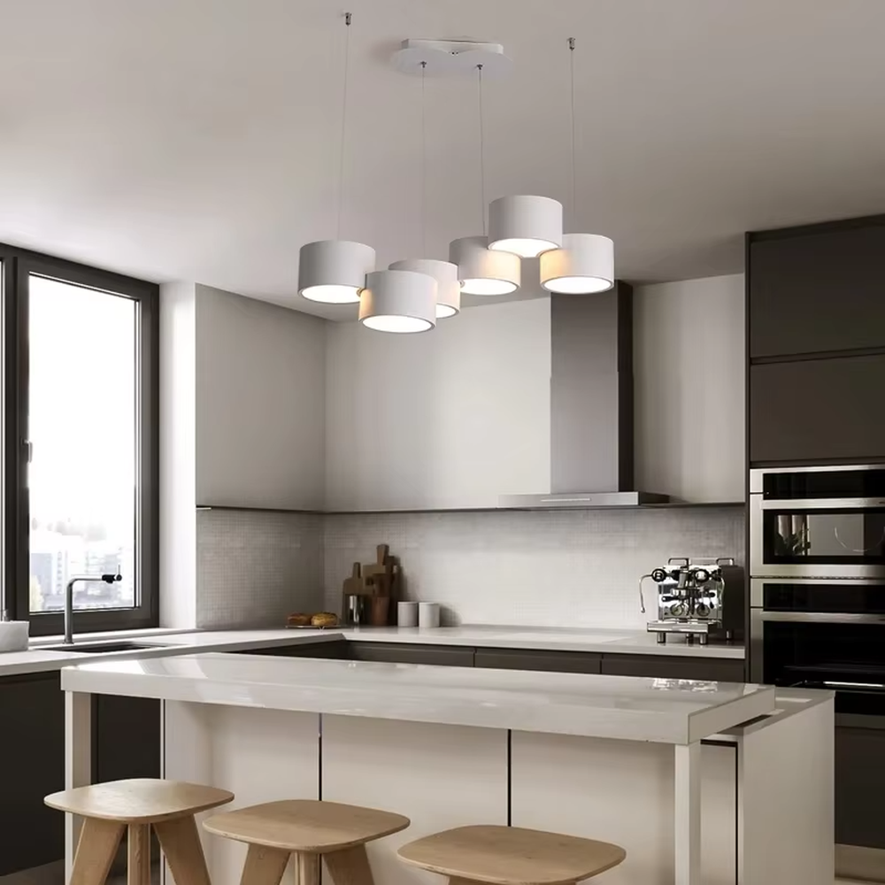 A modern minimalist multi-head cylindrical chandelier, featuring a white metal housing with a staggered stacked layout, built-in LED light source. It emits soft and uniform warm light when lit, combining decorative appeal with practical illumination, ideal for creating a minimalist and fresh space atmosphere.