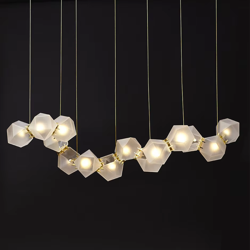 A modern light luxury style wave-shaped linear chandelier, suspended by gold wires, paired with frosted geometric polyhedral lampshades. It emits a soft and warm glow when lit, combining decorative appeal with practical illumination, ideal for creating an exquisite and high-end space atmosphere.