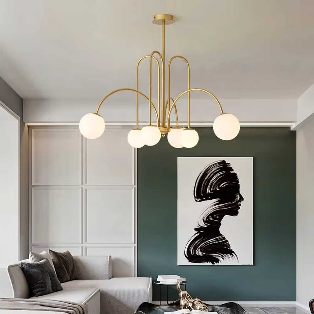 A multi-head chandelier combining modern light luxury and French retro styles, featuring a gold metal curved branch frame paired with milky white glass glowing spheres of varying sizes. It emits soft and uniform warm light when lit, combining decorative appeal with practical illumination, ideal for creating an elegant and dynamic space atmosphere.