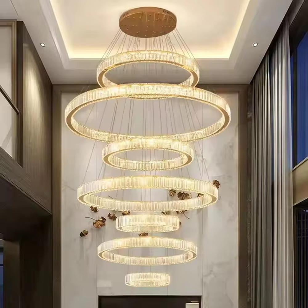 This modern light luxury multi-layer interlaced ring crystal chandelier features a gold metal frame paired with a high-transparency crystal lamp body. The multi-layer rings are staggered and interwoven to present a dynamic interstellar shape. The light refracts through the crystal to emit a brilliant and soft glow, serving both lighting and decorative purposes, suitable for modern light luxury style spaces such as living rooms and dining rooms.