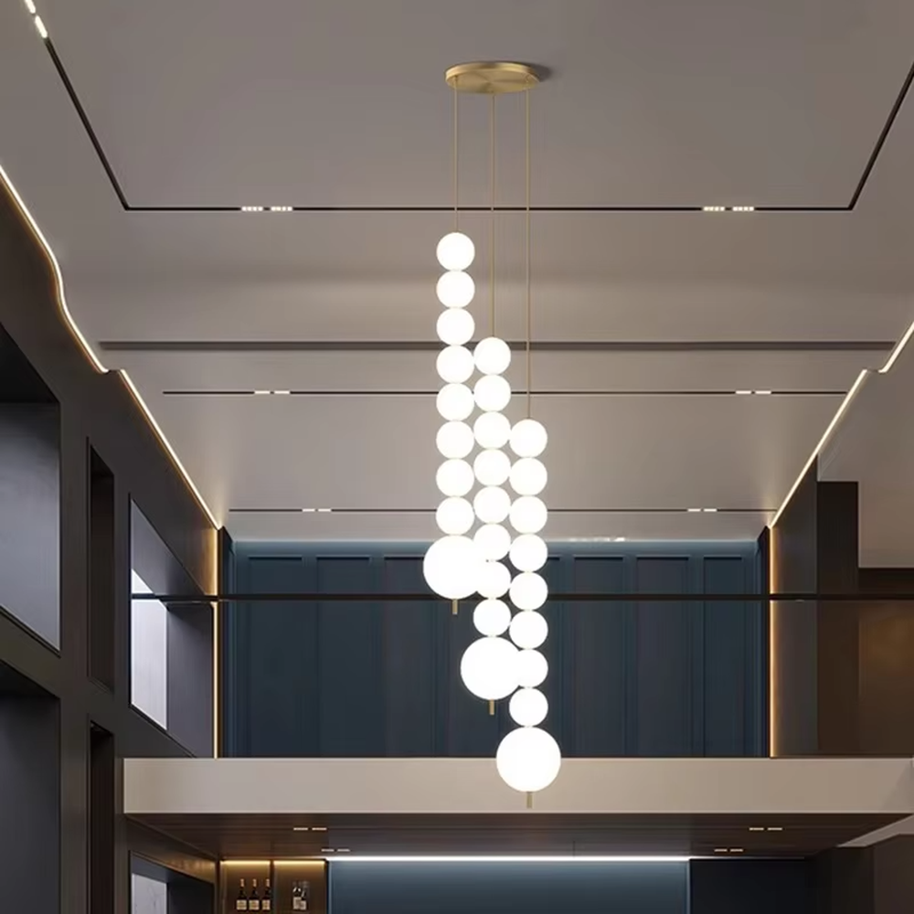 Modern Light Luxury Cascading Dual-Strand Sphere Chandelier, Composed of Milk White Spherical Lamps Connected in a Layered Drooping Design, Gold Metal Ceiling Base, Serves Both Lighting and Decorative Purposes, Ideal for High-Ceiling Dining Rooms, Villa Living Rooms, Duplex Stairwells, etc.