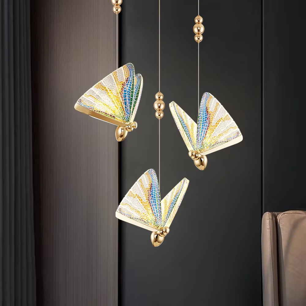 Light luxury butterfly-wing shaped single-head chandelier, with butterfly wing textures made of colored mosaic glass, paired with a gold metal base and hanging structure. It emits soft, transparent, and colorful light, combining artistic decorativeness and lighting function, suitable for atmosphere creation and supplementary lighting in spaces such as entrances, bedroom nightstands, and dining bars.