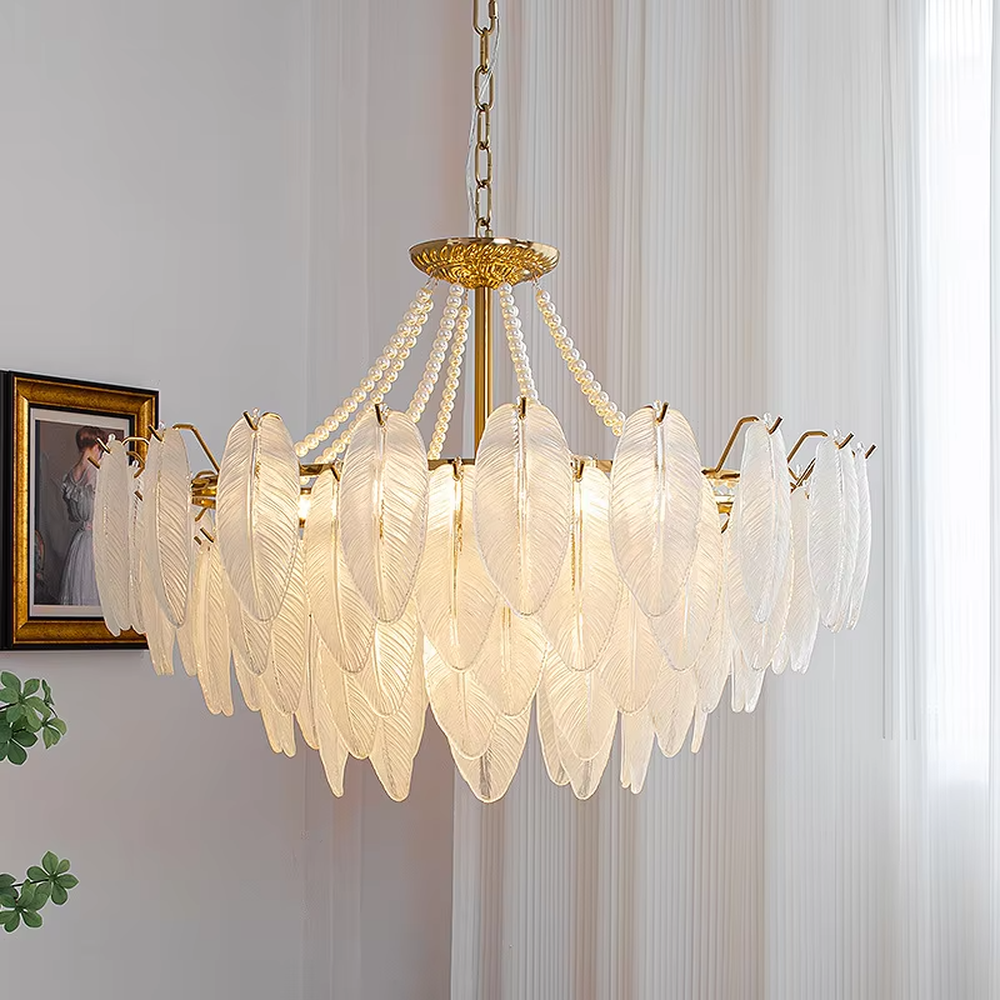 A French light luxury style feather glass chandelier, featuring a gold metal frame paired with double-layer feather-textured glass panels and pearl chain decorations. It emits a soft and warm glow when lit, combining decorative appeal with practical illumination, ideal for creating a romantic and elegant space atmosphere.