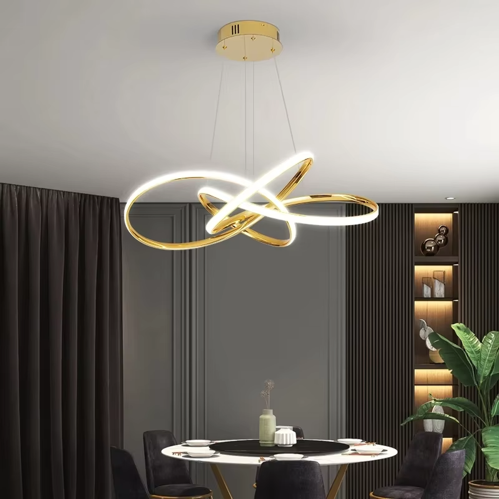 A modern light luxury style interwoven ring LED chandelier, featuring a smooth interwoven multi-ring frame made of gold metal, with built-in high-brightness LED strips. It emits soft and uniform warm light when lit, combining decorative appeal with practical illumination, ideal for creating a minimalist and sophisticated space atmosphere.