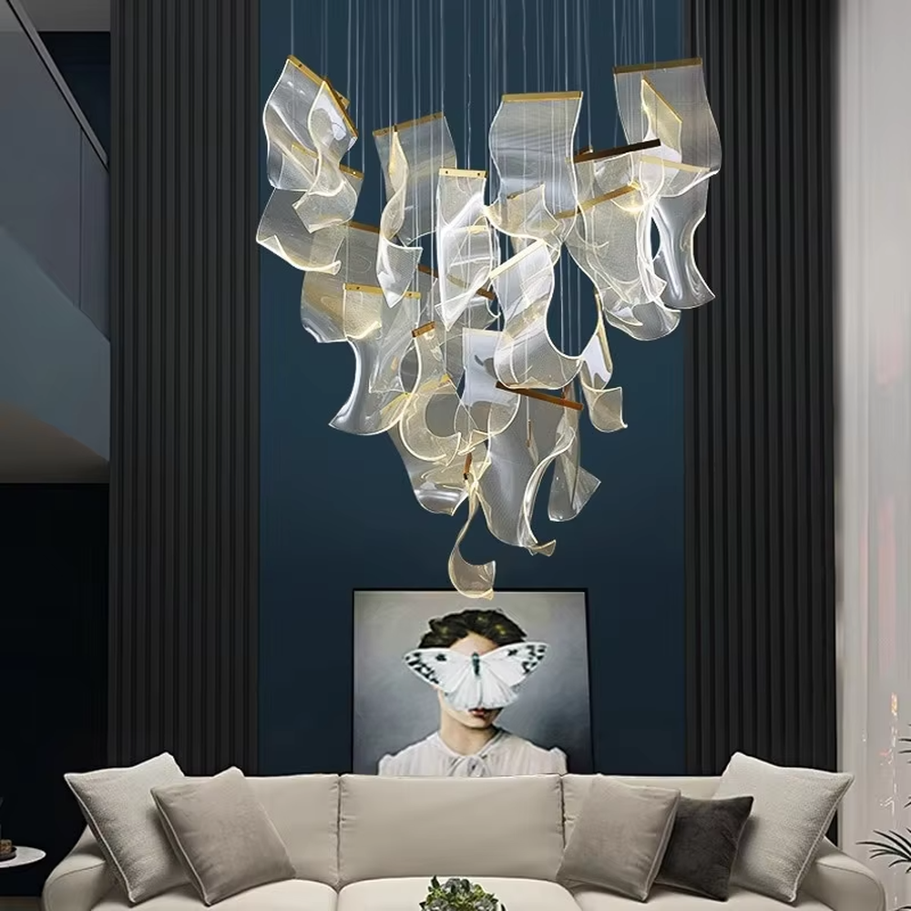 A modern light luxury style layered art chandelier, featuring irregularly folded transparent glass panels suspended by thin wires, with gold trim on the edges. It emits a soft and transparent glow when lit, combining decorative appeal with practical illumination, ideal for creating a high-end and dreamy space atmosphere.
