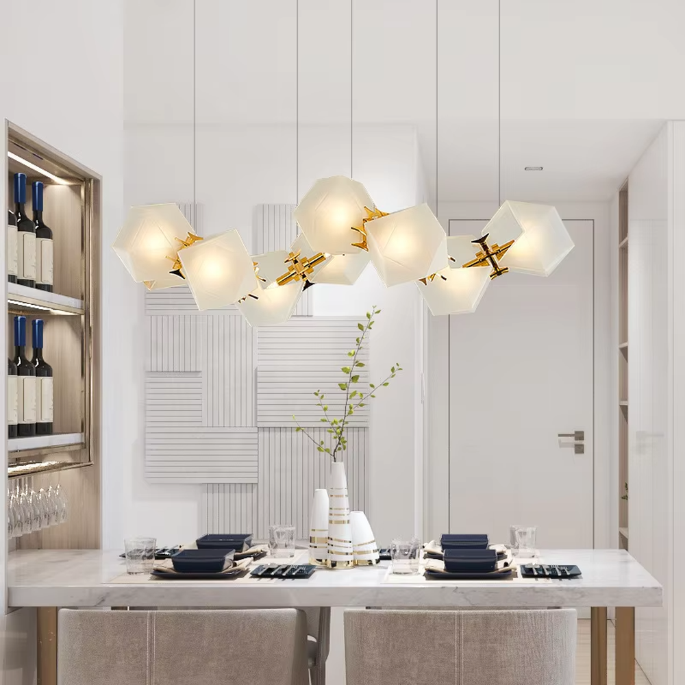 A modern light luxury style wave-shaped linear chandelier, suspended by gold wires, paired with frosted geometric polyhedral lampshades. It emits a soft and warm glow when lit, combining decorative appeal with practical illumination, ideal for creating an exquisite and high-end space atmosphere.