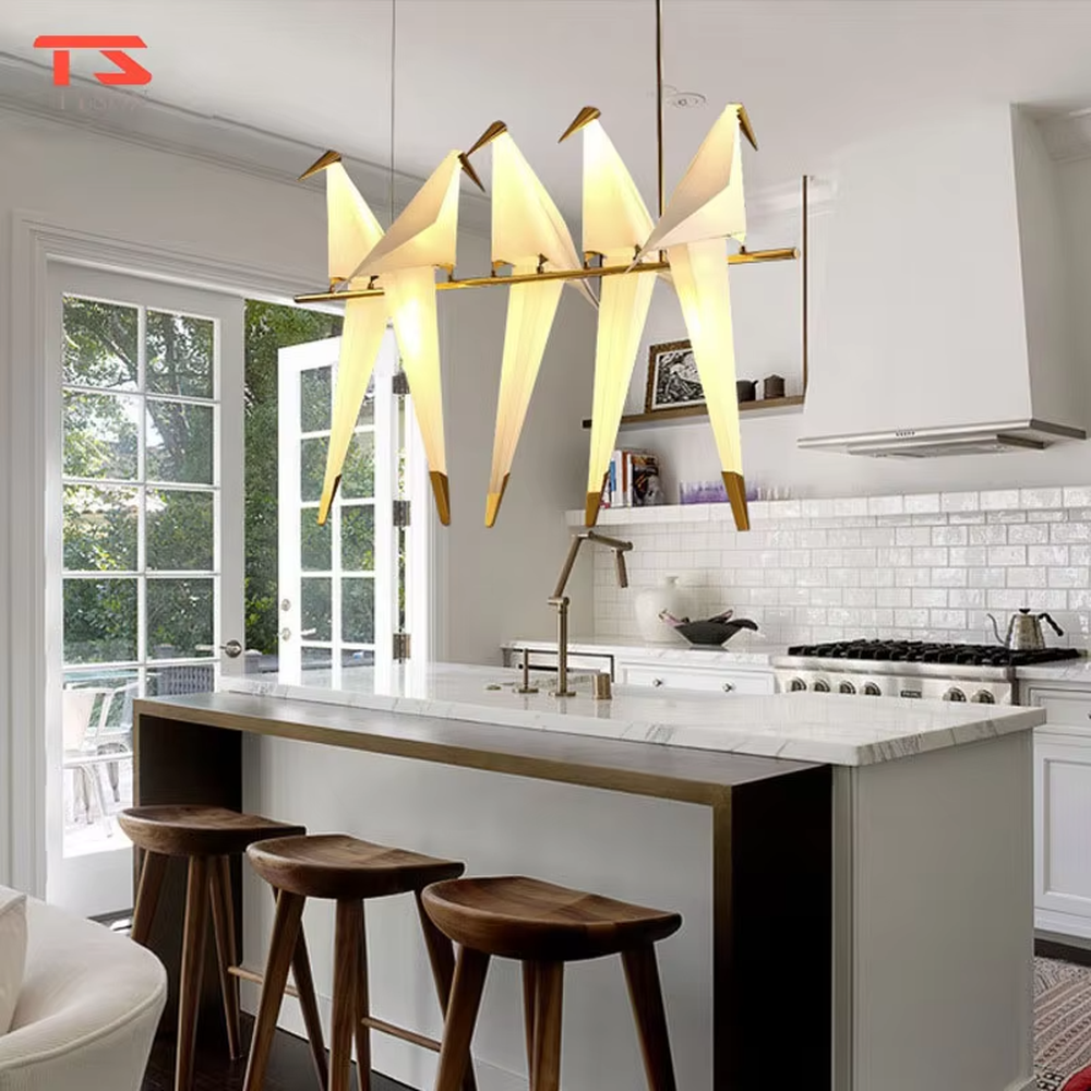 A modern art light luxury style origami crane chandelier, featuring a gold metal ring frame paired with an origami-style white translucent lampshade, shaped like an origami crane perched in a gold ring. It emits a soft and warm glow when lit, combining decorative appeal with practical illumination, ideal for creating an elegant and soothing space atmosphere.