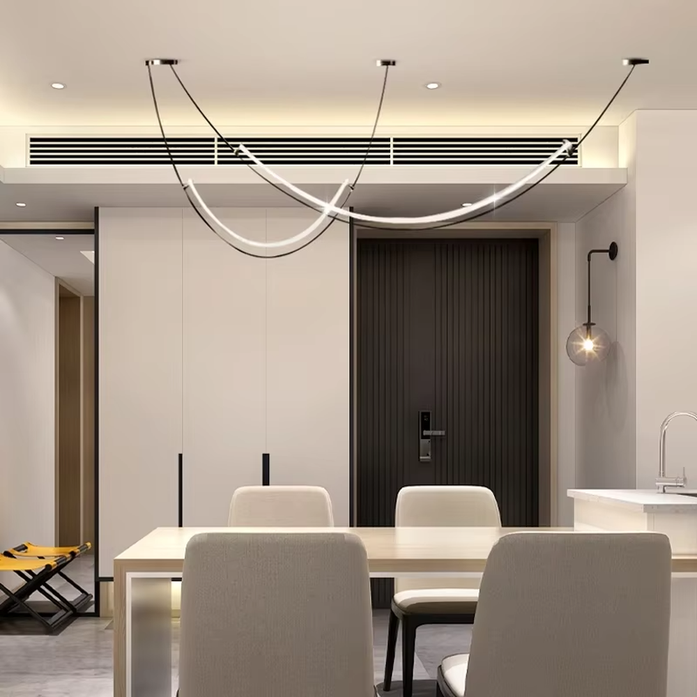 A modern minimalist style double-arc linear chandelier, featuring a black metal frame with built-in white LED light strips, shaped like flowing light arcs suspended in space. It emits a soft and uniform glow when lit, combining decorative appeal with practical illumination, ideal for creating a minimalist and sophisticated space atmosphere.