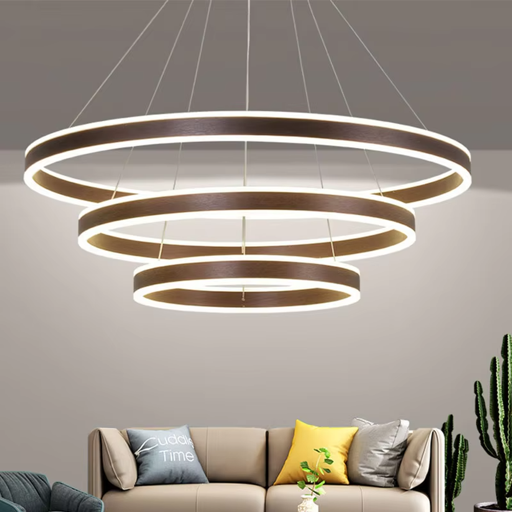 A modern light luxury three-tier ring LED chandelier, featuring a gold metal frame with built-in soft light strips and adjustable suspension rods for different ceiling heights, combining lighting and decorative functions, ideal for creating a minimalist and sophisticated space atmosphere.