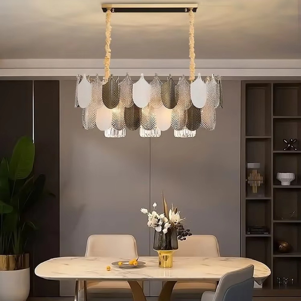 This modern light luxury leaf art chandelier is composed of gold and transparent leaf-shaped ornaments arranged in staggered layers, presenting a light and elegant shape like spreading feathers. Light refracts through the ornaments to emit a soft and transparent halo, serving both lighting and decorative purposes, suitable for modern light luxury style spaces such as living rooms and dining rooms.
