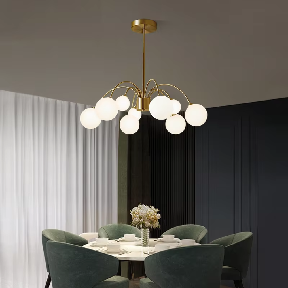 A modern light luxury style firefly chandelier, featuring a gold metal curved branch frame paired with multiple milky white glass glowing spheres of varying sizes, shaped like a blooming dandelion or flying fireflies. It emits a soft and uniform glow when lit, combining decorative appeal with practical illumination, ideal for creating a romantic and dynamic space atmosphere.