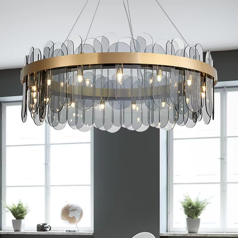 A modern light luxury style ring chandelier, featuring a gold metal frame paired with gradient transparent circular glass panels. It emits a soft and brilliant glow when lit, combining decorative appeal with practical illumination, ideal for creating an elegant and sophisticated space atmosphere.
